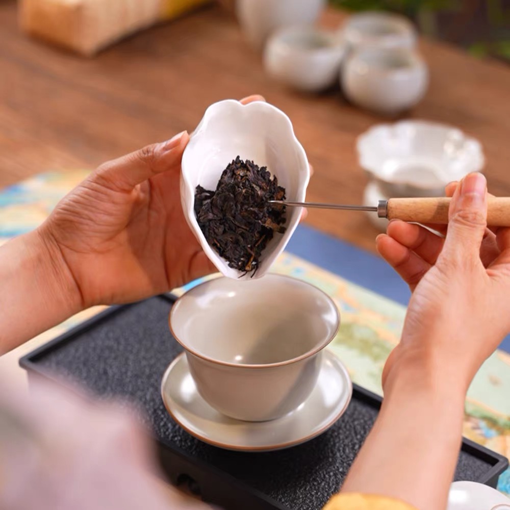 A small piece of Ya'an dark tea being placed into a cup